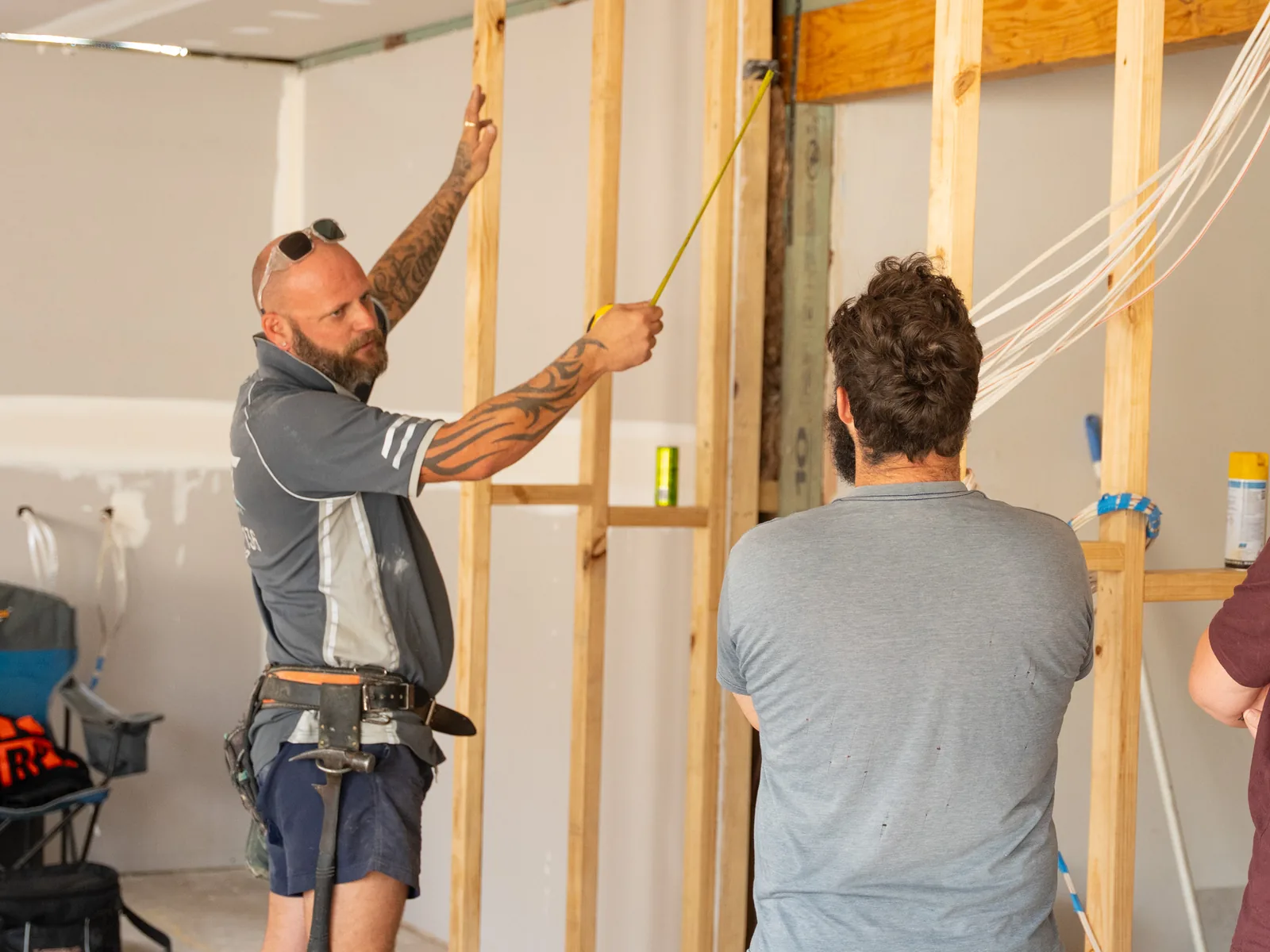 Carpenters setting out a new internal stud wall during a renovation