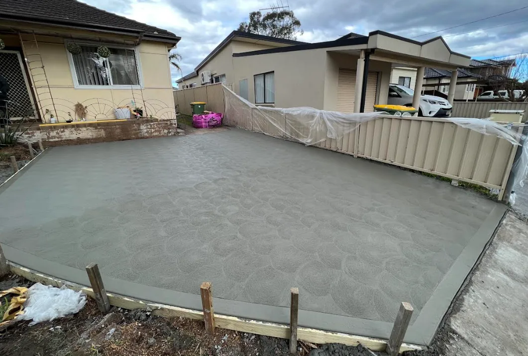 Finished concrete slab in a rear yard with a swirl finish