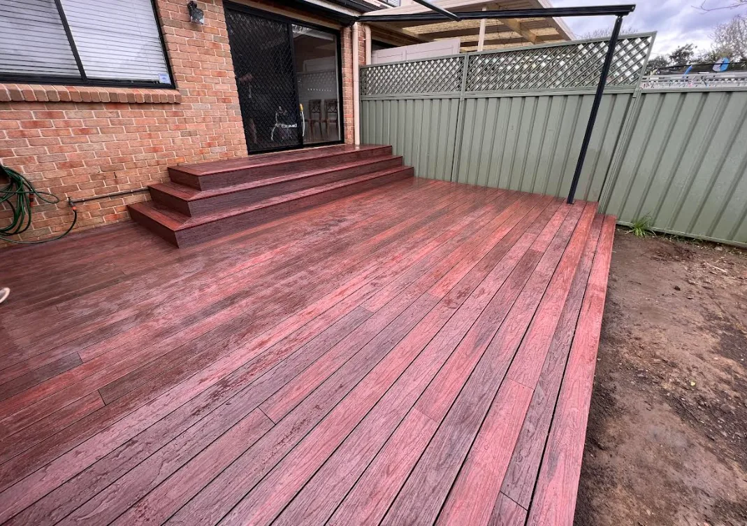 Completed hardwood deck with steps leading to the back door