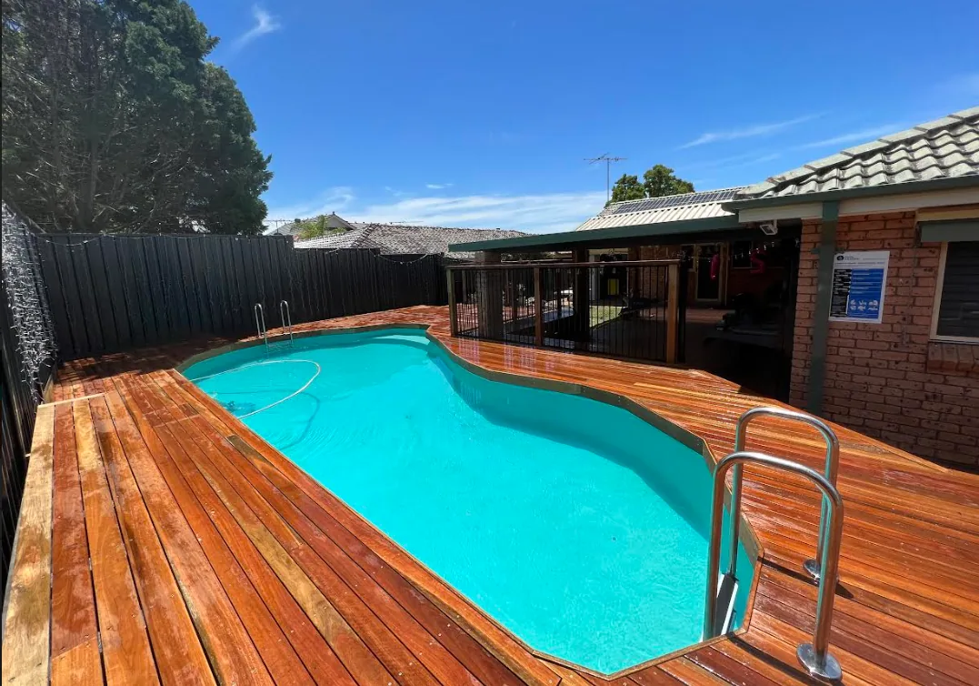 Completed inground pool with hardwood decking and a covered outdoor area at the renovated Russell Lea home