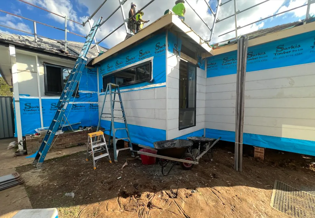 Home extension under construction with new cladding and scaffolding