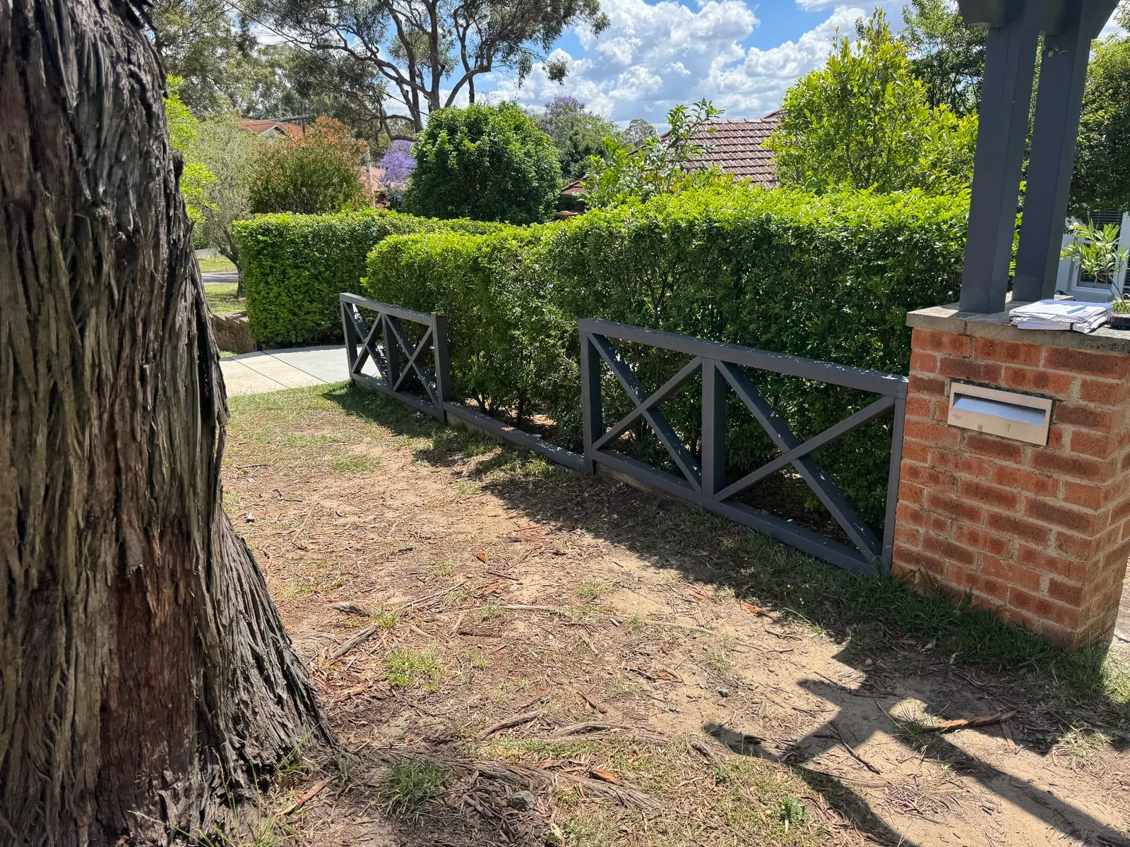 The original painted timber cross rail front fence at Oatley before the new slat fence was installed
